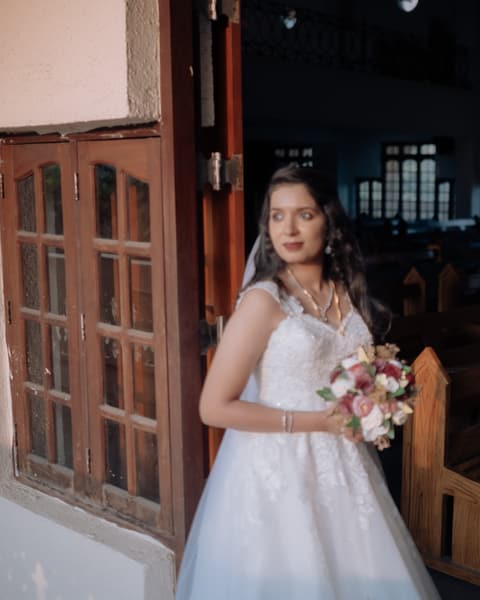Bride holding her bouquet at the church door