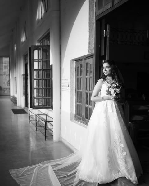 Bride by a window, in black and white
