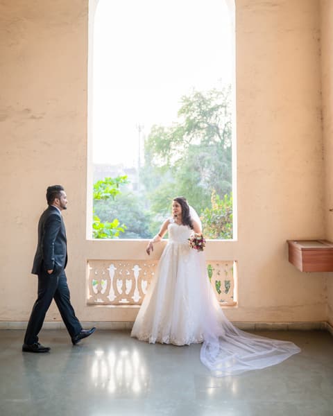 Groom walking toward the bride through an arch